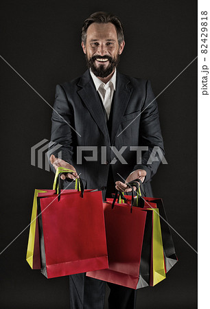Happy to share. Man mature shopper carries shopping bags Happy to share. Man mature shopper carries shopping bags 82429818