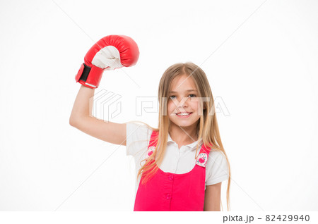 Girl on smiling face posing with boxing glove, isolated Girl on smiling face posing with boxing glove, isolated 82429940