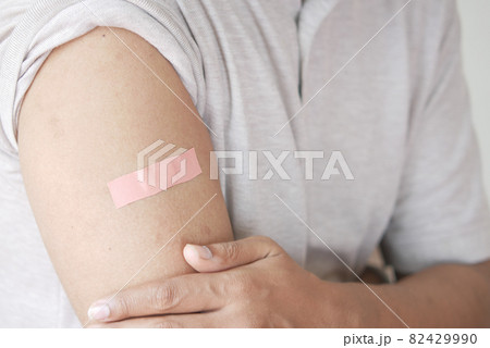 adhesive bandage on young man's arm  82429990