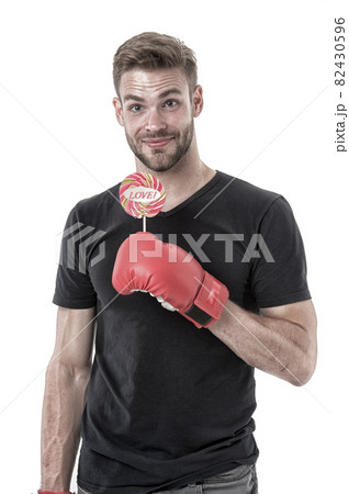 Man hold lollipop in boxing glove. Healthy food .Love and power. Valentines day, vintage filter 82430596