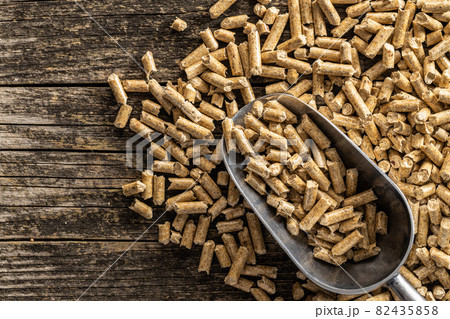 Wooden pellets in scoop. Ecological heating. 82435858