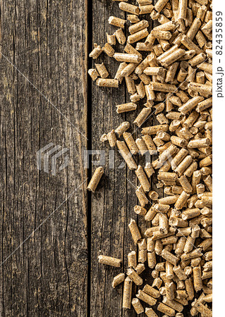 Wooden pellets on old wooden table. Ecological heating. Wooden pellets on old wooden table. Ecological heating. 82435859