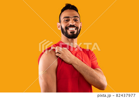 Vaccinated Man Showing Arm With Plaster After Vaccination, Yellow Background Vaccinated Man Showing Arm With Plaster After Vaccination, Yellow Background 82437977
