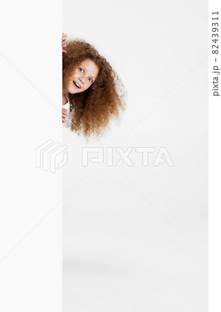 Portrait of beuatiful cute girl with funny hairdo having fun isolated on white background. Happy childhood concept 82439311