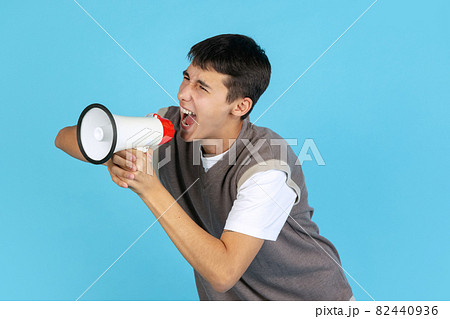 Portrait of young man, student or boy in casual clothes isolated on blue studio backgroud. Human emotions concept. Portrait of young man, student or boy in casual clothes isolated on blue studio backgroud. Human emotions concept. 82440936