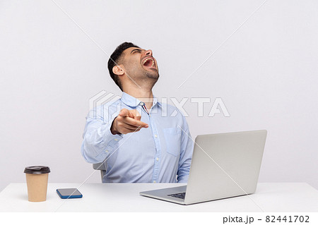 Emotional man sitting and working on office Emotional man sitting and working on office 82441702