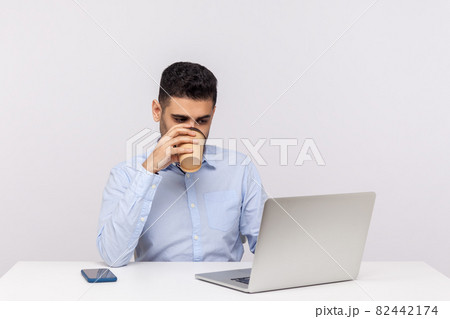 Emotional man sitting and working on office 82442174