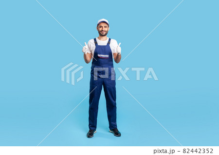Portrait of worker man in uniform on blue background. Portrait of worker man in uniform on blue background. 82442352