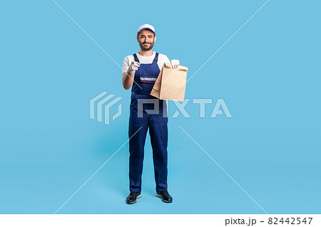 Portrait of worker man in uniform on blue background. 82442547