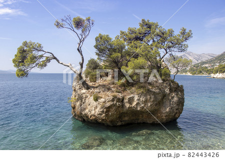 Small stone islet on Punta Rata beach in Brela 82443426