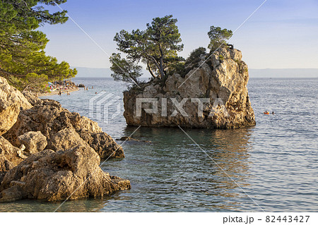Small stone islet on Punta Rata beach in Brela 82443427
