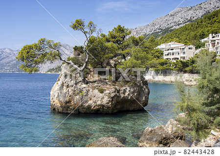Small stone islet on Punta Rata beach in Brela Small stone islet on Punta Rata beach in Brela 82443428