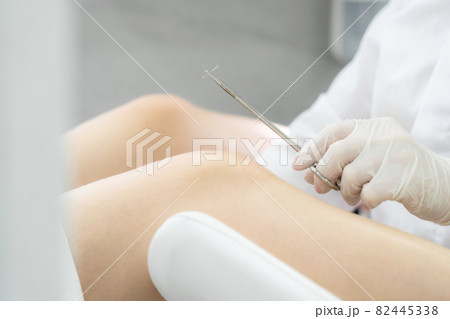 Gynecologist holding needle for stitching before surgery Gynecologist holding needle for stitching before surgery 82445338