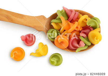 Raw colored pasta in wooden spoon isolated on white background with clipping path and full depth of field. Top view. Flat lay 82446009