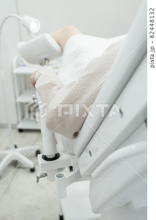 patient laying in gynecology chair in gynecologist office patient laying in gynecology chair in gynecologist office 82448132