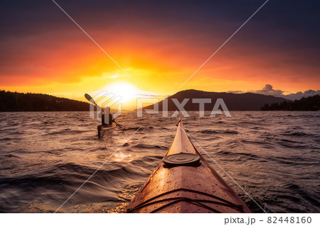 Adventurous Woman on Sea Kayak paddling in the Pacific Ocean. Adventurous Woman on Sea Kayak paddling in the Pacific Ocean. 82448160