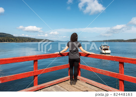 Woman on a Wooden Pier by the Pacific Ocean West Coas Woman on a Wooden Pier by the Pacific Ocean West Coas 82448163