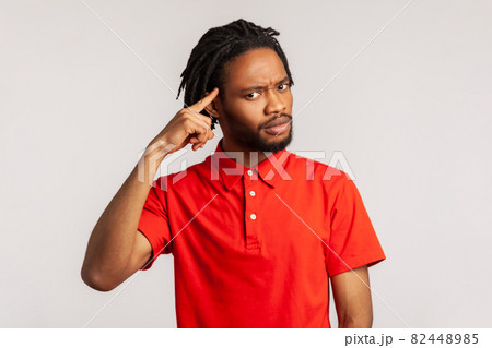 Portrait of young emotional african man on gray background. 82448985