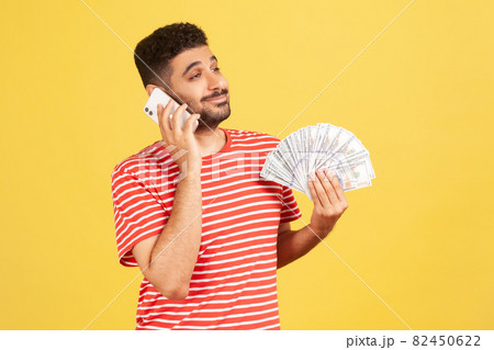 Emotional young man in red t-shirt on yellow background. 82450622