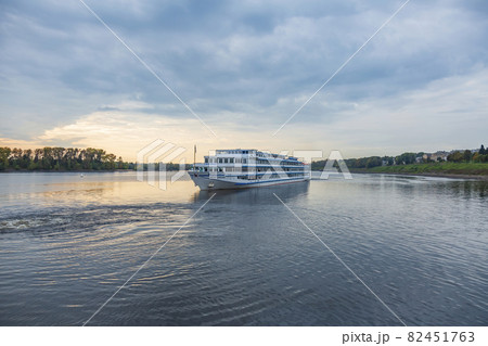 Comfortable four-deck ship is sailing on the river Comfortable four-deck ship is sailing on the river 82451763
