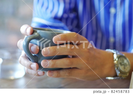 マグカップで飲み物を飲む男性 82458783