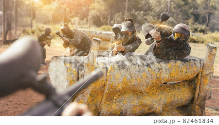 Paintball players playing outdoors 82461834