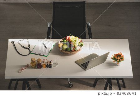Workplace of dietician with vegetables and supplements on table Workplace of dietician with vegetables and supplements on table 82463641
