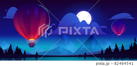 Hot air balloons fly over mountain lake at night 82464541