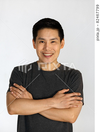 Portrait of a young and handsome Asian man folding arms with self-confident posing 82467799