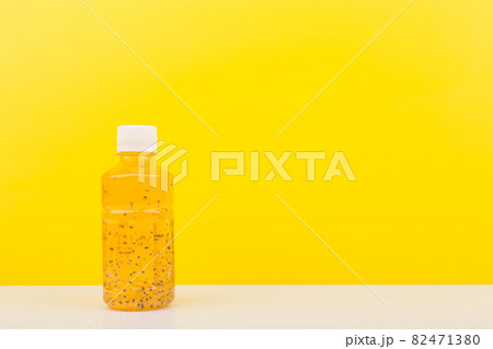 Detox drink or juice with chia seeds on white table against yellow background with copy space Detox drink or juice with chia seeds on white table against yellow background with copy space 82471380