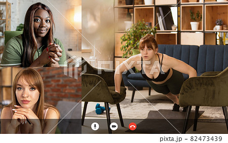 Young multiethnic people watching together online fitness trainings, sport tv programme using video app. PC, laptop screen Young multiethnic people watching together online fitness trainings, sport tv programme using video app. PC, laptop screen 82473439