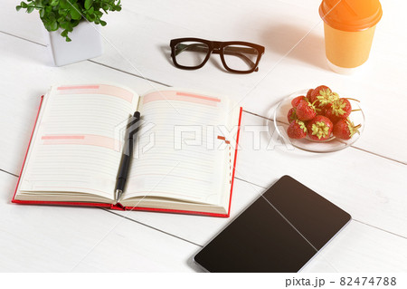 Stylish minimalistic workplace with tablet and notebook and glasses in flat lay style. White background. Stylish minimalistic workplace with tablet and notebook and glasses in flat lay style. White background. 82474788