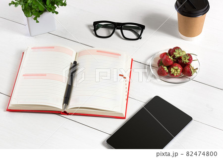 Stylish minimalistic workplace with tablet and notebook and glasses in flat lay style. White background. 82474800