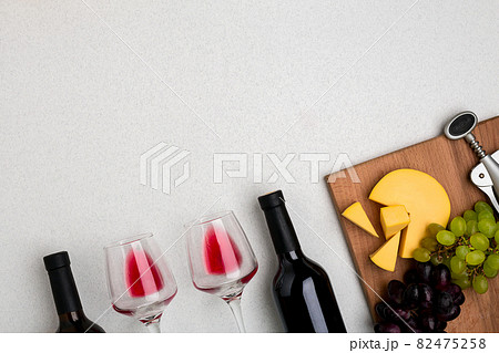 Glasses and bottles of red and white wine on white background from top view Glasses and bottles of red and white wine on white background from top view 82475258