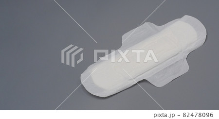 Napkin sanitary. Soft and comfort sanitary napkin pad and grey background. White top sheet. Studio shot isolated. Cloth pads for menstruation. Wing type for night. Quick absorber. cotton soft feeling. 82478096