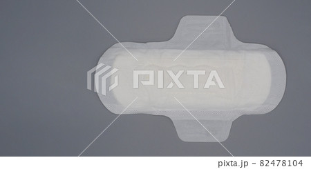 Napkin sanitary. Soft and comfort sanitary napkin pad and grey background. White top sheet. Studio shot isolated. Cloth pads for menstruation. Wing type for night. Quick absorber. cotton soft feeling. 82478104