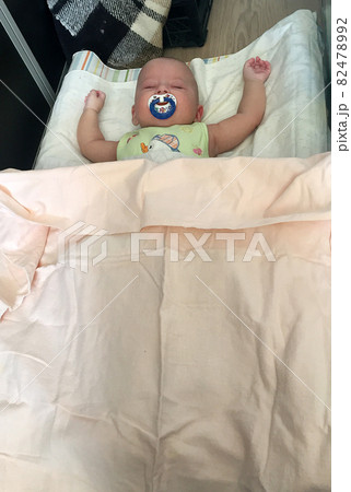 Sleeping baby boy with child pacifier posing photographer for color photo Sleeping baby boy with child pacifier posing photographer for color photo 82478992