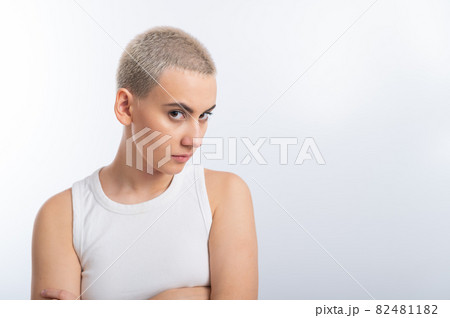 Displeased young caucasian woman with short haircut on white background. Displeased young caucasian woman with short haircut on white background. 82481182