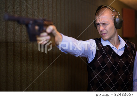 Shooting a combat pistol in shooting range 82483057