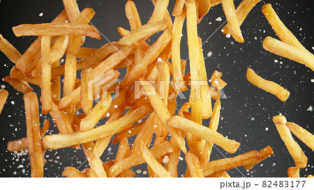 Freeze motion of flying french fries on black background 82483177