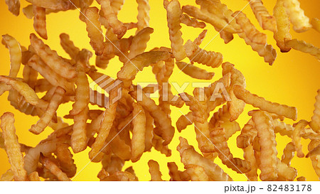 Freeze motion of flying french fries on golden background Freeze motion of flying french fries on golden background 82483178