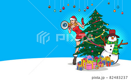 Santa girl peeking from behind christmas tree with megaphone 82483237