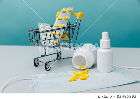 Mini trolley with medical goods on a blue backround. Online shopping concept 82485892