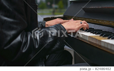 hands of a man, a guy who plays a melody on the piano hands of a man, a guy who plays a melody on the piano 82486402