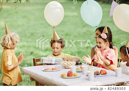 Children Enjoying Birthday Party in Summer Children Enjoying Birthday Party in Summer 82489303