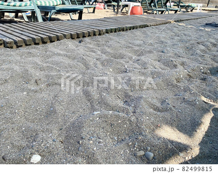 Wooden boardwalk at a sandy beach Wooden boardwalk at a sandy beach 82499815