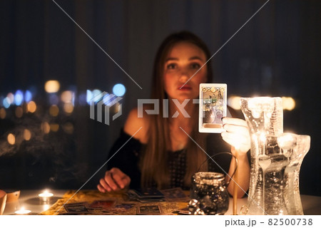 Woman reading tarot cards in spiritual room. 82500738