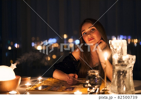 Woman reading tarot cards in spiritual room. Woman reading tarot cards in spiritual room. 82500739