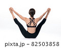 Beautiful sporty woman doing advanced yoga practice on white bac 82503858