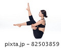 Beautiful sporty woman doing advanced yoga practice on white bac 82503859